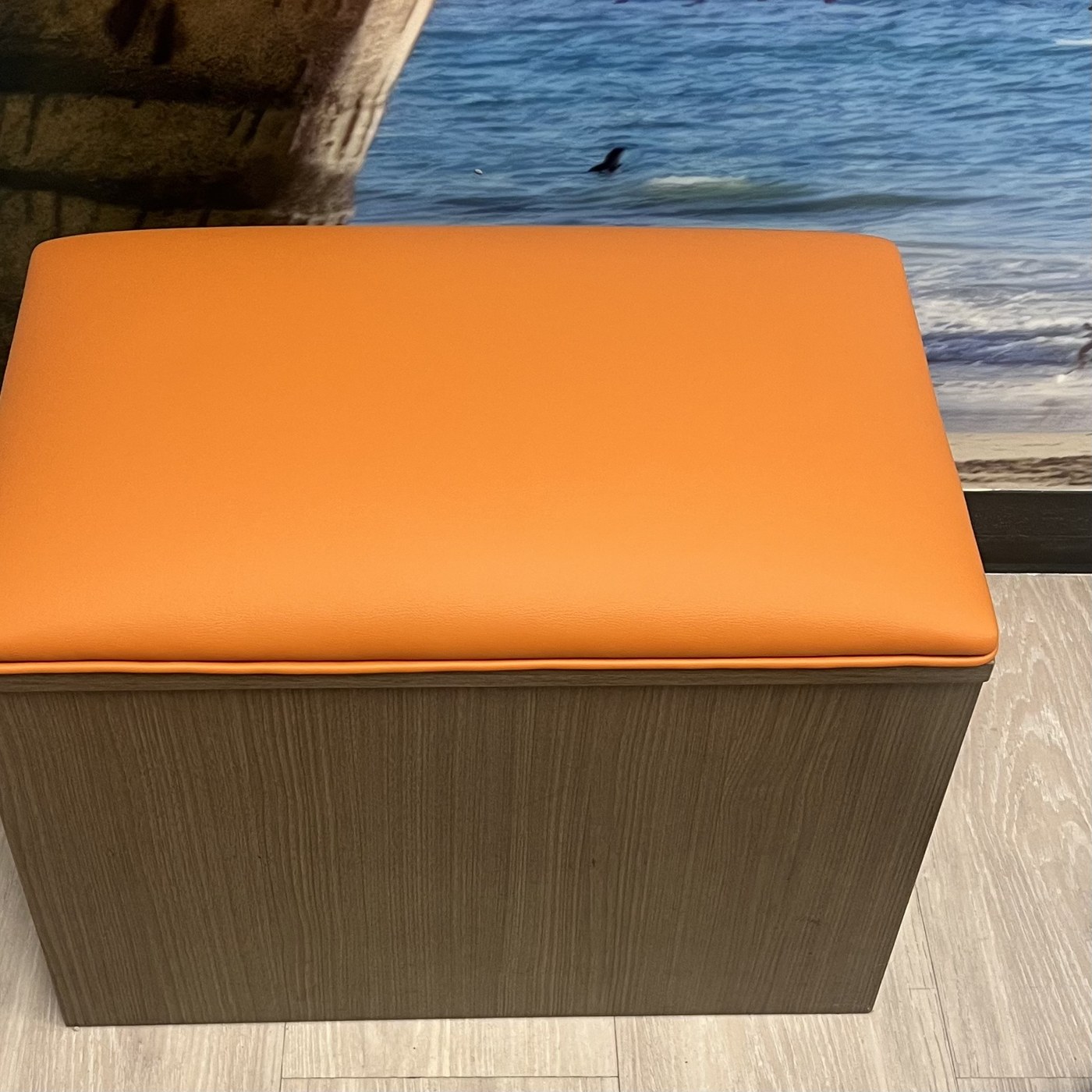 Storage ottoman restored in orange upholstery